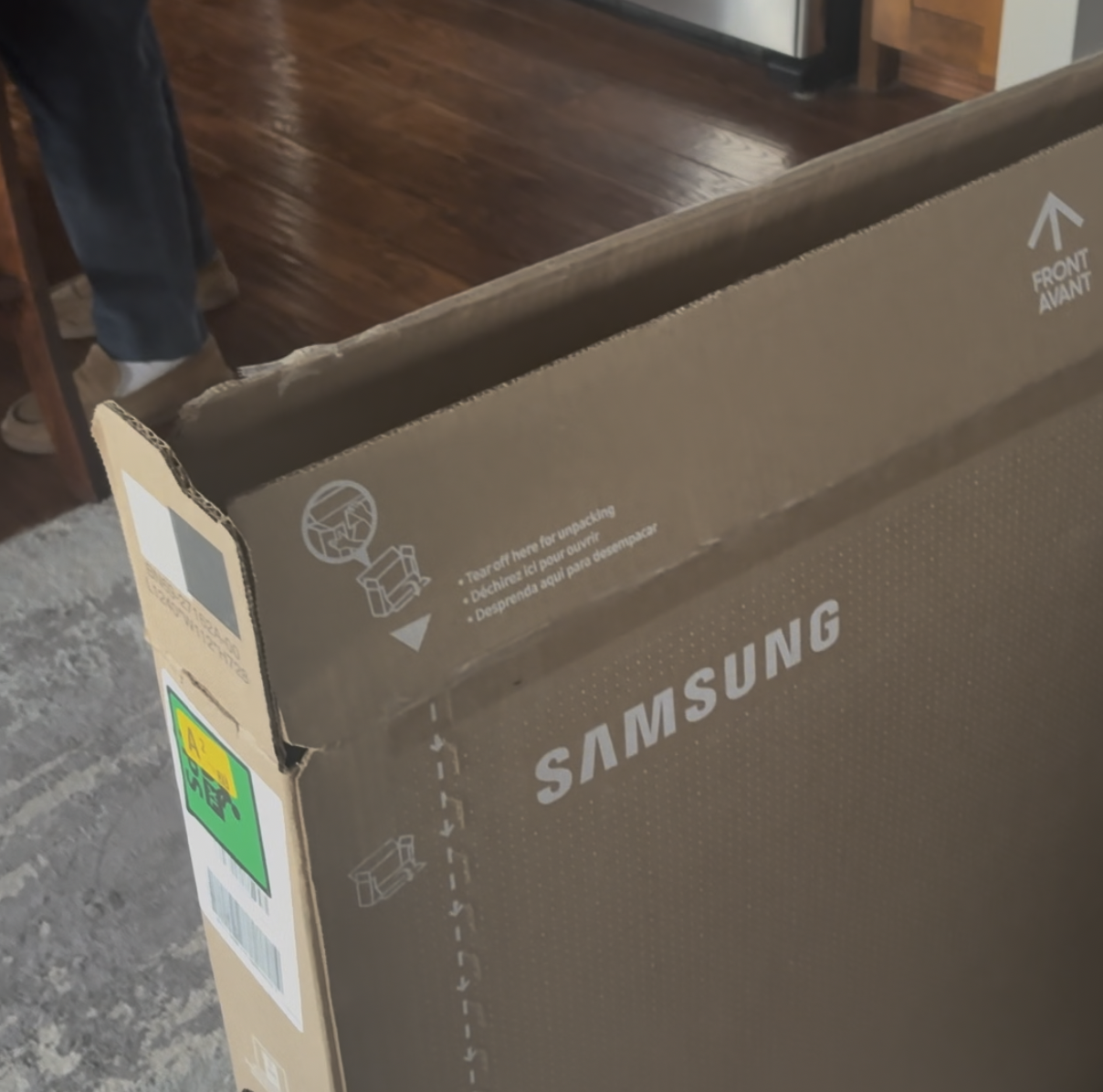 My father unboxing a new television. The picture is screenshotted from the video the audio is from.