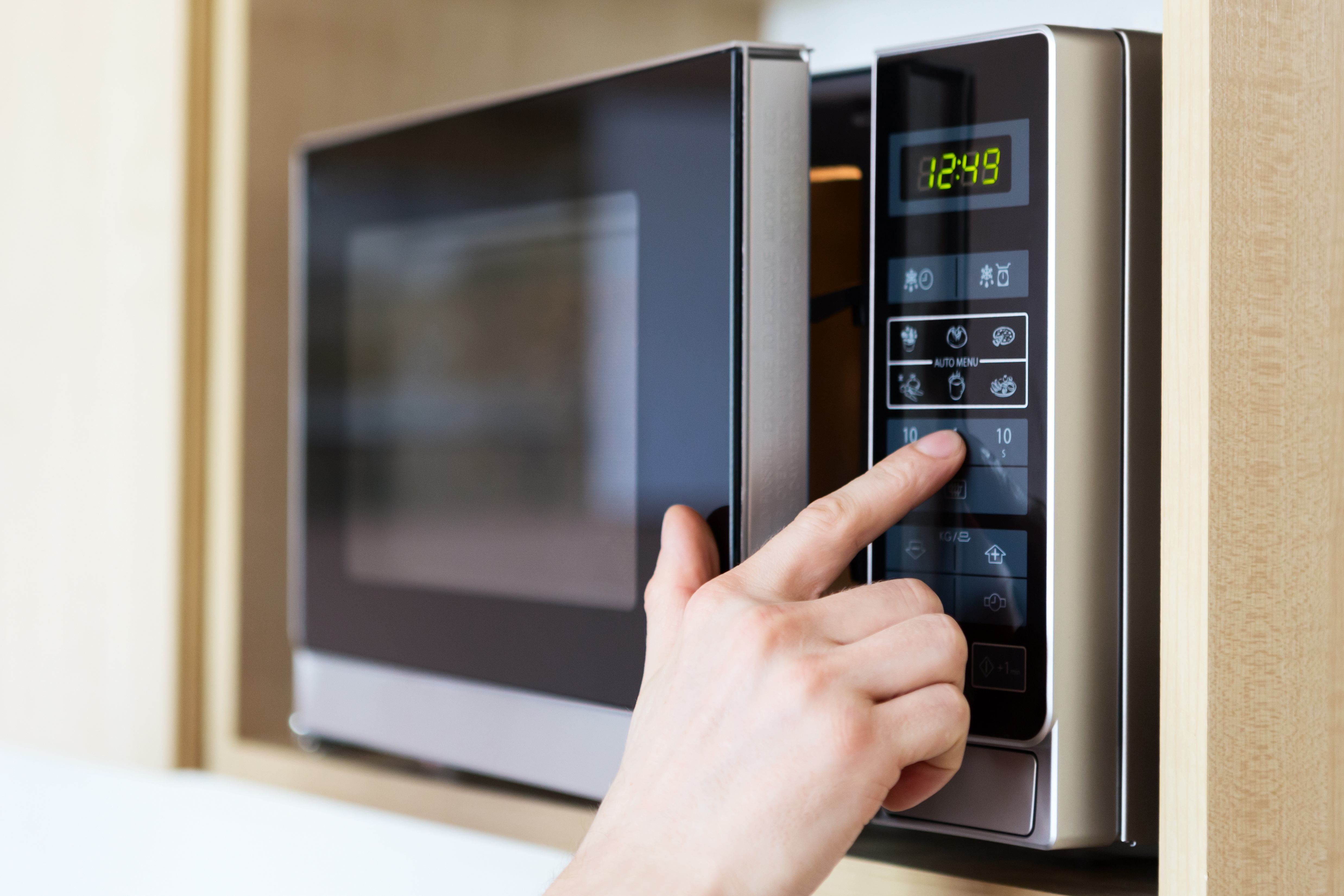 Opening and closing a microwave door and pressing the buttons.